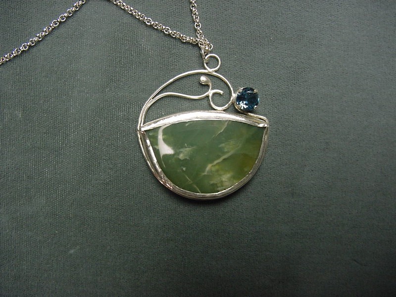 handcrafted pendant featuring a large green agate cabochon and faceted blue topaz