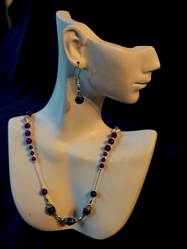 purple amethyst and sterling silver neclace and earring set on jewelry display form
