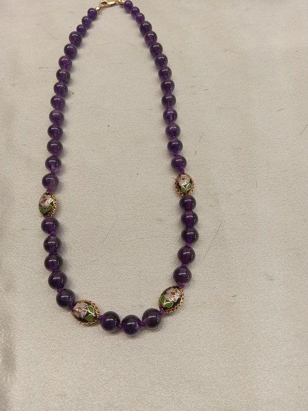 picture of strung amethyst beads accented with cloisonne beads