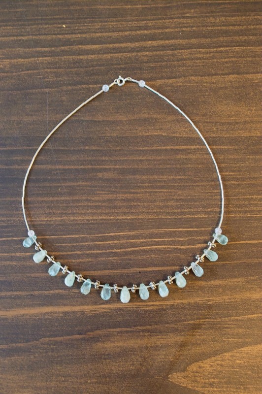 16 inch sterling silver necklace with a center of sterling silver, aquamarine teardrop beads. and quartz beads.