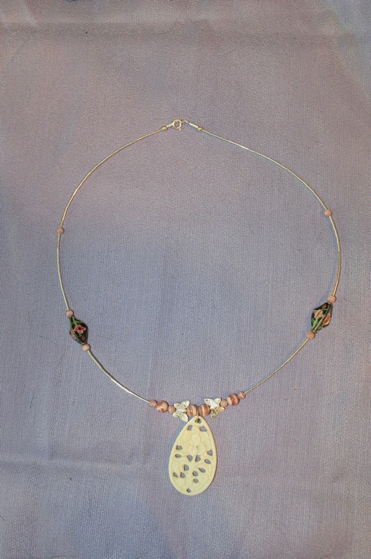 19 inch necklace plus carved bone pendant is made of sterling silver, rhodochrosite beads, and accent cloisonne beads.