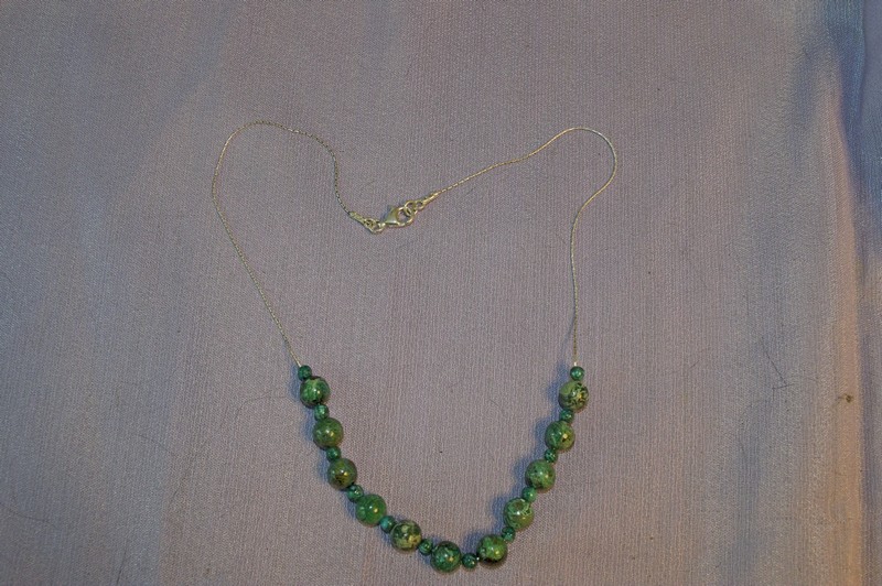 16 inch necklace of sterling silver beading chain featuring blue-green chrysocolla beads in a central arc.