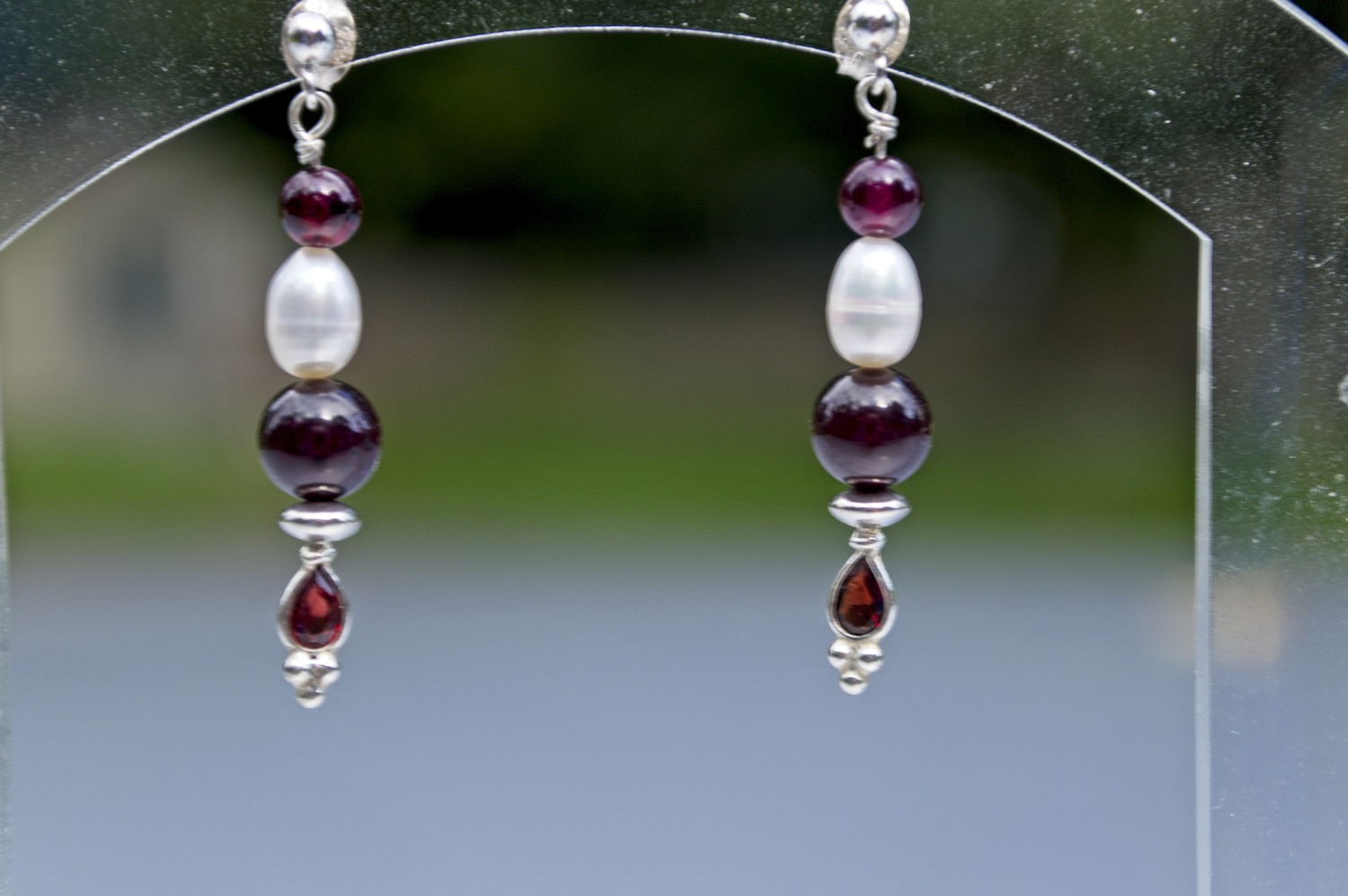 picture of silver, freshwater pearl, and garnet earrings