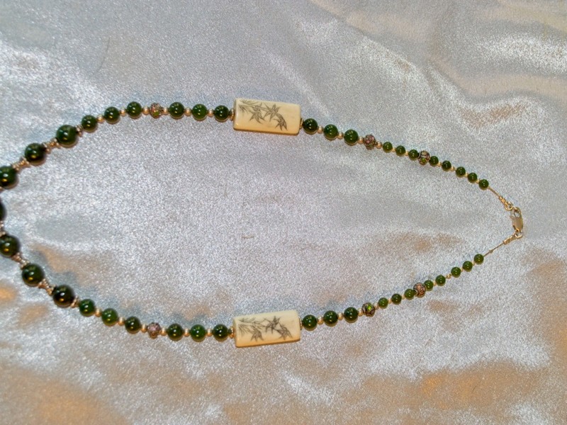 20 inch necklace made of jade beads, cloisonne, sterling silver beads, and bone beads strung on sterling beading chain