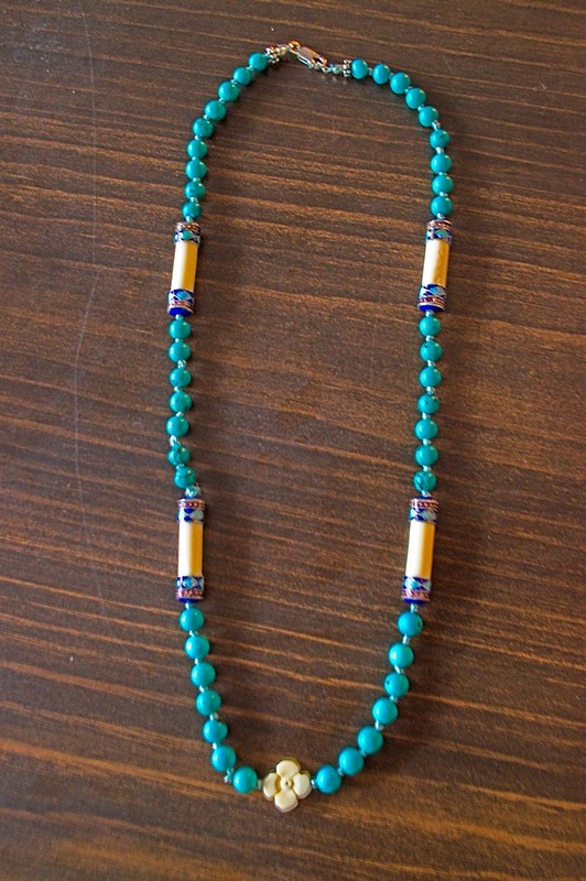 picture of long necklace of turquoise and specialty bone beads hand knotted on silk